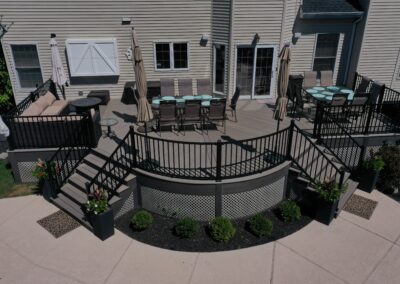 Custom curved deck in Mahwah using composite decking and aluminum railings with lattice skirting