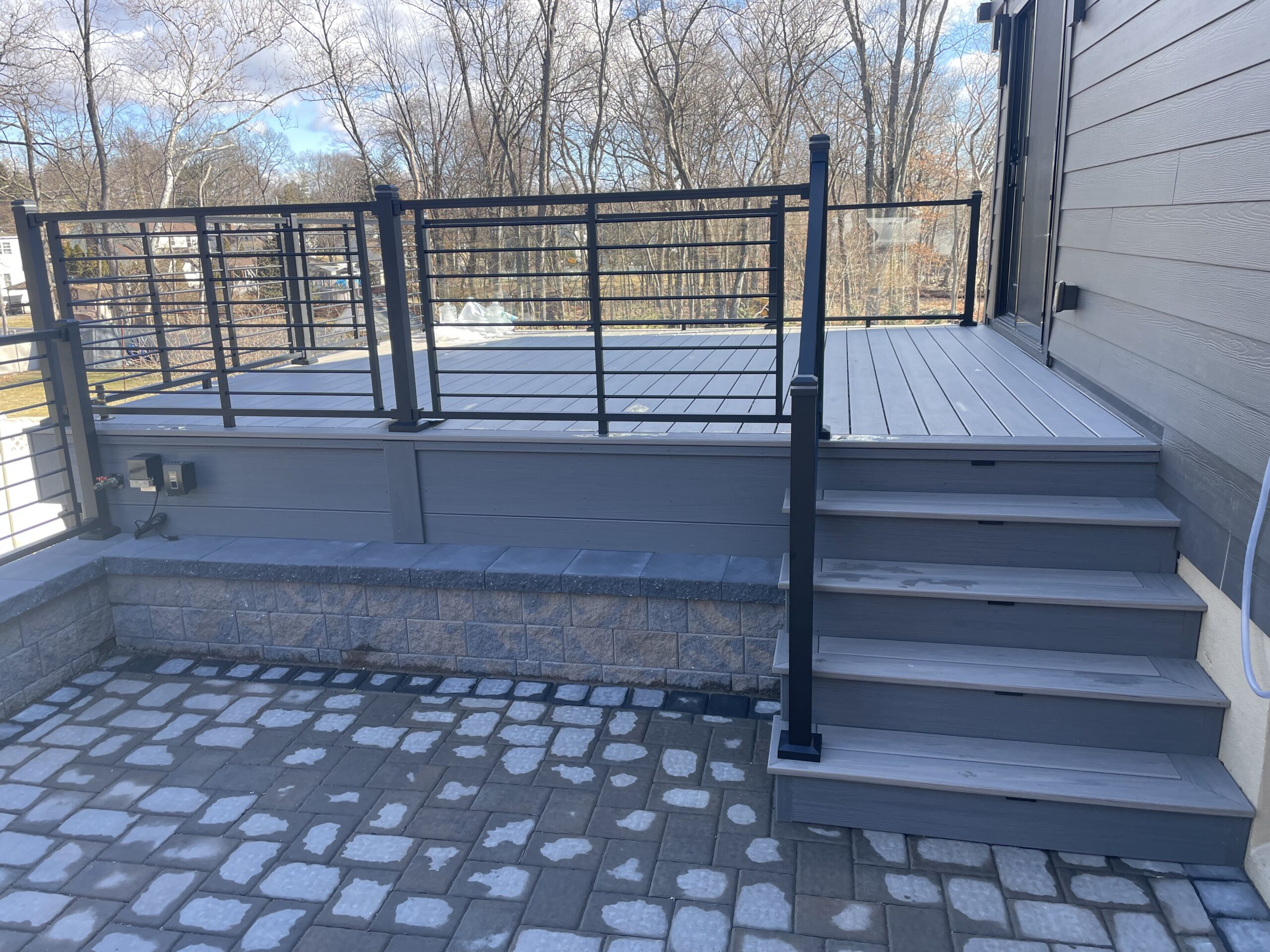 Deck in Park Ridge using composite decking and aluminum rod and glass railings