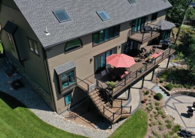 Custom deck and balcony on a lake in Wayne with composite decking and cable railings
